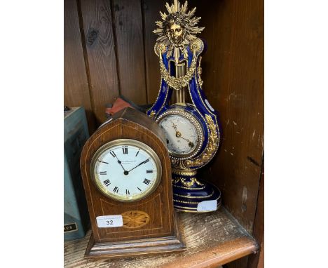 An early 20th century oak cased mantle clock together with a ceramic and gilt decorated mantle clock.The wooden cased one has