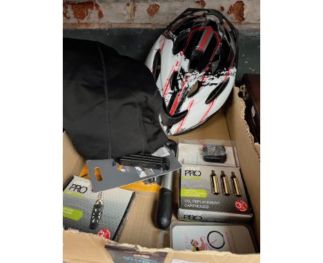 A box of bicycle accessories to include helmet, CO2 inflator with cartridges, light set, etc. 