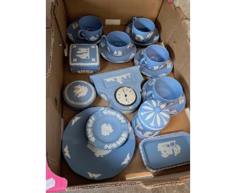 A box of assorted Wedgwood blue Jasper ware including cups and saucers and a clock etc.All in good condition apart from the c