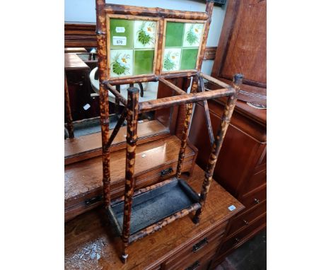 A late 19th century bamboo stick stand with tile back and drip tray. 