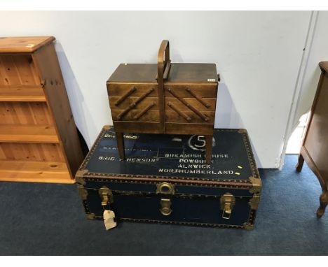 A blue travel trunk and a sewing box