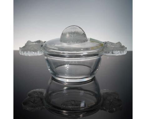 This Lalique crystal lidded dish is beautifully designed with delicately molded lilypad motifs in frosted crystal extending f