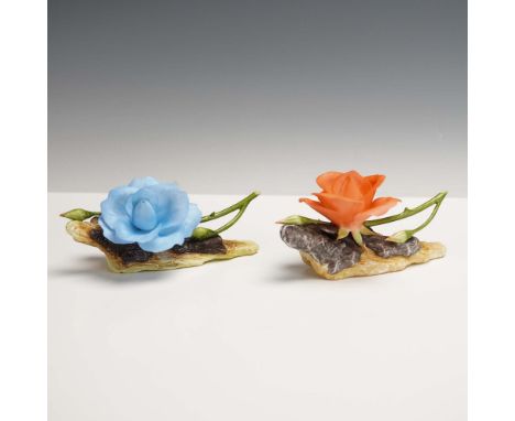 This striking pair of Boehm porcelain rose figurines features a cool-toned blue bloom (model 200-55-B) and a warm salmon-colo