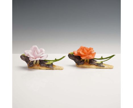 This pair of Boehm porcelain figurines features a lifelike rendition of a single rose in full bloom, one in soft pink (model 