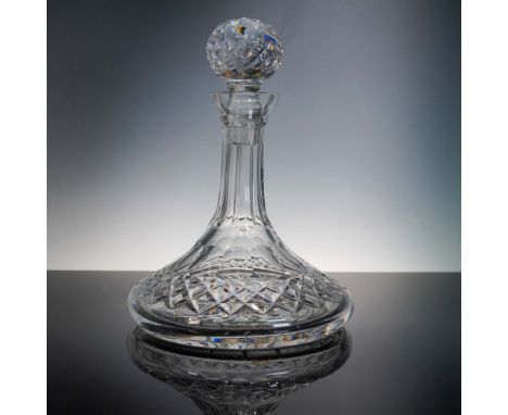 This elegant crystal spirit decanter by Waterford features a broad, flat base with deeply cut diamond and wedge motifs, taper