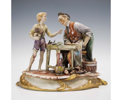 Lovely hand painted porcelain figure depicting a heartwarming scene of a cobbler seated at his workbench engaging with a youn