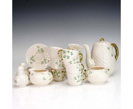 This 29-piece Belleek porcelain tea set features the iconic Irish Shamrock pattern, delicately hand-painted on a creamy ivory