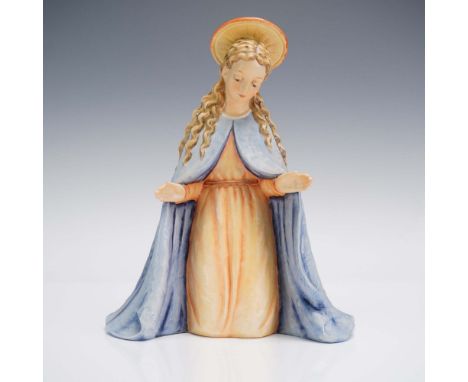 A reverent and delicately modeled  figurine depicting the Virgin Mary. The Madonna is portrayed with downcast eyes, hands gra