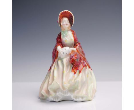 Made of fine bone china, this female figure is adorned in a voluminous dress with soft floral accents and a red marbled shawl