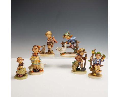 Collection of six vintage Hummel Goebel porcelain figurines depicting children in various charming poses, including scenes wi