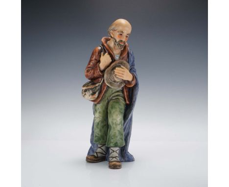 This impressive hand-painted porcelain figurine by Goebel of West Germany portrays a humble shepherd in motion, carrying a sa