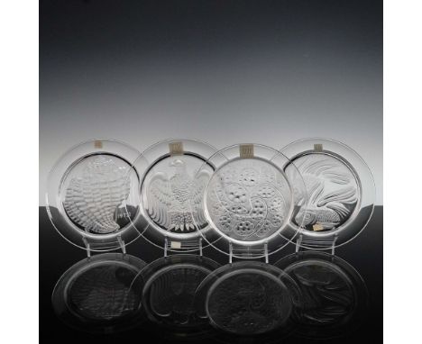 This exquisite set of four Lalique crystal plates, crafted in France between 1972 and 1976, represents the refined artistry o