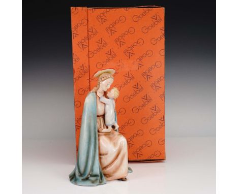 This tender Goebel porcelain figurine titled Madonna and Child (model HM112) portrays the Virgin Mary seated in flowing robes