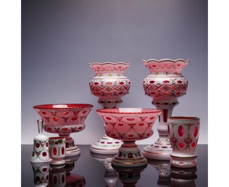 A vibrant 8 piece set of  glassware richly decorated with hand painted floral garlands and gilt accents over a white cased gr