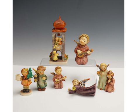 Set of seven hand-painted porcelain figurines in the style of Hummel, depicting angels and children in various charming scene