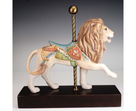 This Cybis porcelain figurine captures a regal carousel lion adorned with an intricately hand-painted saddle in vibrant tones