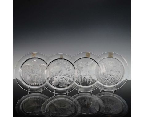 This set of four Lalique crystal plates includes a series of exquisitely molded designs issued annually from 1973 to 1976. Ea