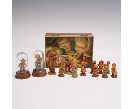 Charming collection of hand carved and painted miniature wooden figurines by ANRI Italy, housed in a gold tone musical treasu