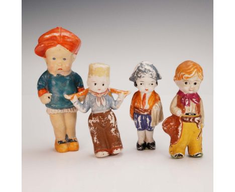 A charming group of four hand-painted bisque figurines, each portraying a boy in colorful period or folk attire. These vintag