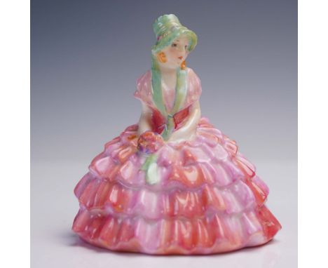 This charming Royal Doulton porcelain figurine, titled Chloe (model M9), showcases a young woman dressed in an elaborate tier