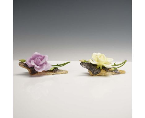 This pair of Boehm porcelain rose figurines features a soft yellow bloom (model 200-55-Y) and a graceful lilac bloom (model 2