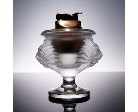 Striking Lalique crystal table lighter featuring a bold lion head motif sculpted in satin-finished relief on both sides. This
