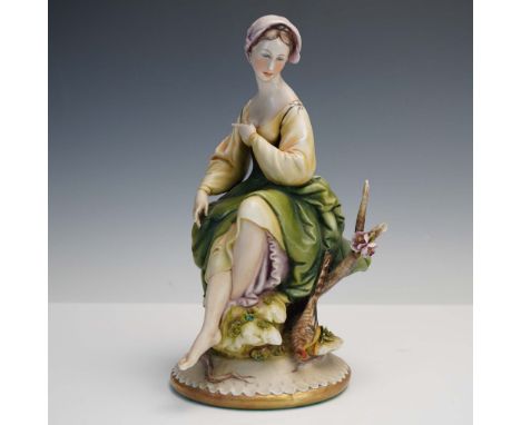 This elegant porcelain figurine by Antonio Borsato captures a serene young woman seated on a mossy rock beside a tree branch,