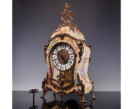 A German clock  in a Rococo Revival style wood case with painted floral motifs and ornate brass mounts. The case features a c