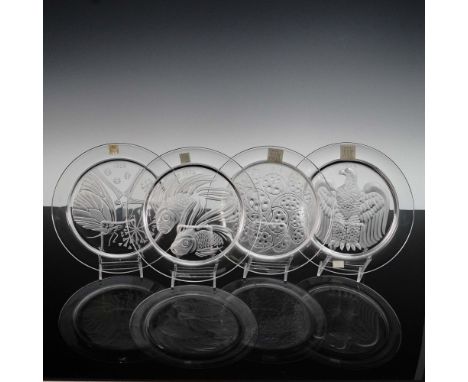 A striking 4-piece ensemble of Lalique crystal annual collector plates from 1969, 1974, 1975, and 1976. The 1976 plate featur