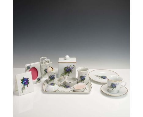 Collection of eleven porcelain pieces, each decorated with delicate violet floral sprays and fine gold trim. This coordinated