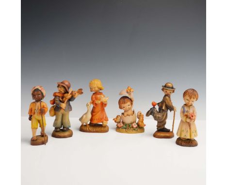 Set of six hand-carved wooden figurines by Anri, Italy, based on designs by artist Juan Ferrandiz. Each figurine features a c