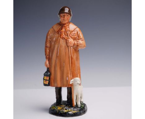 Depicts a standing male figure wearing a brown cap and a full-length brown coat with a textured scarf. The figure holds a lan