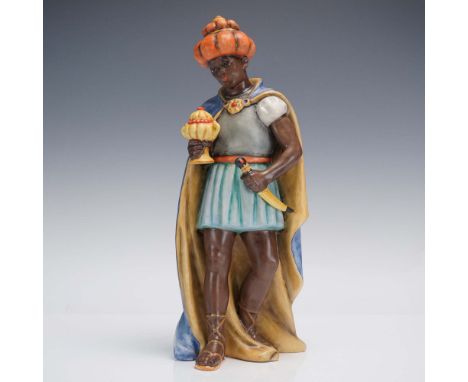 Fine porcelain figurine depicting one of the Magi or Three Kings, elegantly attired in a regal blue and gold cloak with a str