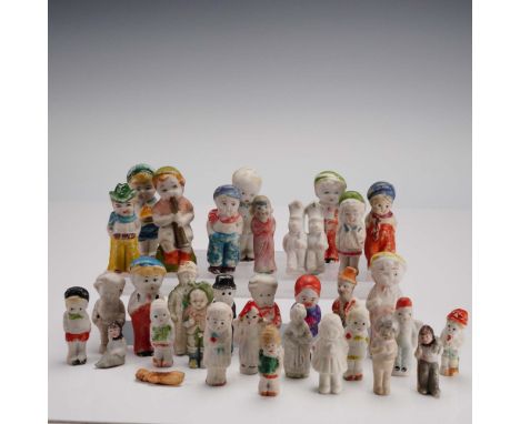 A delightful assembly of thirty-four vintage bisque porcelain Frozen Charlotte and Frozen Charlie dolls, each exhibiting uniq