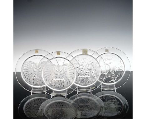 A beautifully curated 4-piece set of Lalique crystal annual collector plates featuring designs from 1965, 1971, and 1974. The