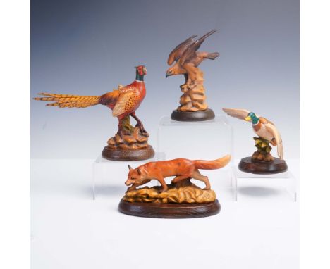 Group of four finely hand-carved and painted wood sculptures by Anri, Italy, featuring wildlife designs by renowned artist Gu