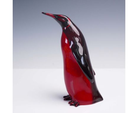 Porcelain figurine produced by Royal Doulton as part of the Flambe collection, featuring a stylized emperor penguin in a stan
