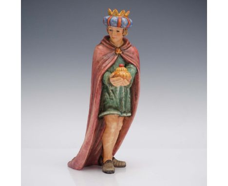 Porcelain hand painted figurine depicting one of the Three Wise Men, standing in reverence while presenting a "gilded" offeri