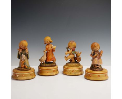 Set of four intricately hand-carved and hand-painted wood musical figurine boxes by Anri, Italy, each designed by Spanish ill