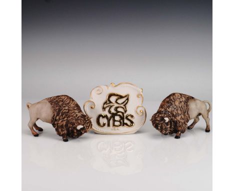 This set features two finely crafted Cybis porcelain American Bison figurines presented with a sculptural Cybis logo plaque. 