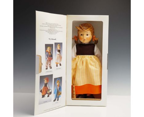 Crafted by the renowned W. Goebel Porzellanfabrik, this charming M.I. Hummel doll titled Birthday Serenade embodies the warmt