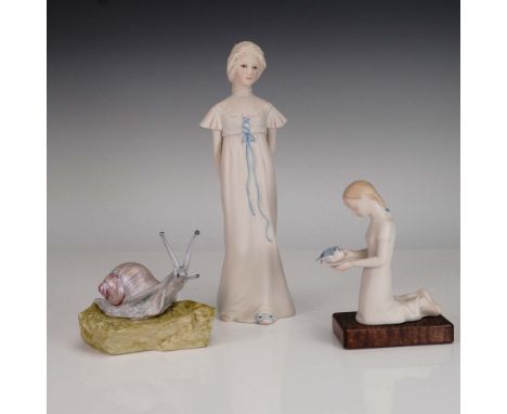 Delightful trio of Cybis porcelain figurines including Betty Blue Young Girl, First Flight, and Sir Henry the Snail, each sho