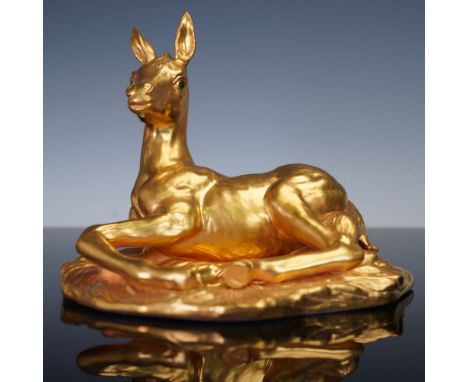 A striking porcelain figurine by Boehm, this limited edition piece depicts a colt finished in radiant gold with vivid green e