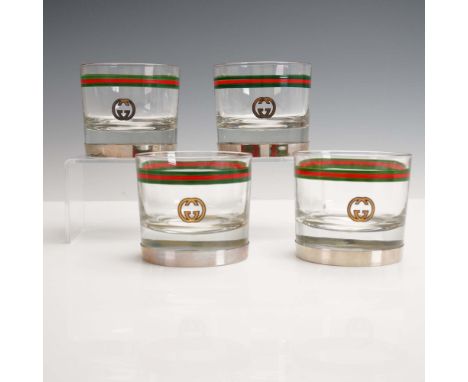 A luxurious 4-piece set of Gucci Italy old fashioned glasses featuring the iconic interlocking GG logo and classic green-red-
