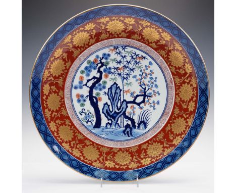 This hand-painted charger plate by Andrea by Sadek features a distinctive Gold Imari design with a central landscape tableau 