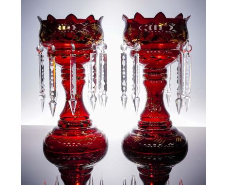 A striking pair of Bohemian ruby red glass mantle lusters, adorned with intricately cut and faceted clear crystal prisms. Eac