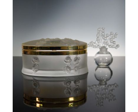 A refined 2-piece Lalique crystal collection featuring a limited edition oval lidded box and a delicately crafted Lily of the