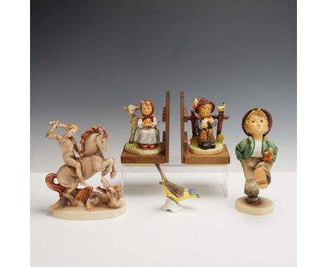 This lot includes five Goebel Hummel pieces: a pair of ceramic bookends, a large figurine of a child, a bird figurine, and a 
