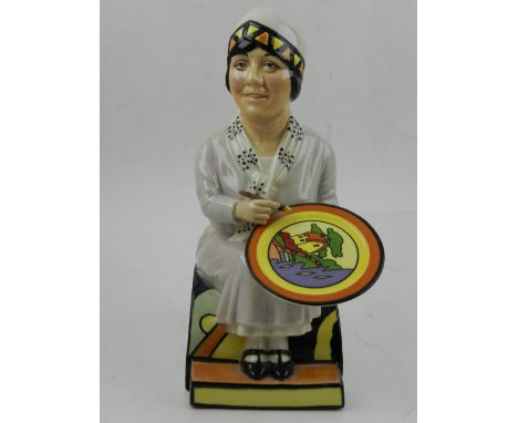 A Kevin Francis 'Clarice Cliff' ceramic jug, modelled as a seated lady painting porcelain. H: 23cm