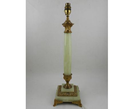 An onyx and ormolu mounted column table lamp, on a stepped base, raised on four metal feet. H: 51cm, together with a plaster 